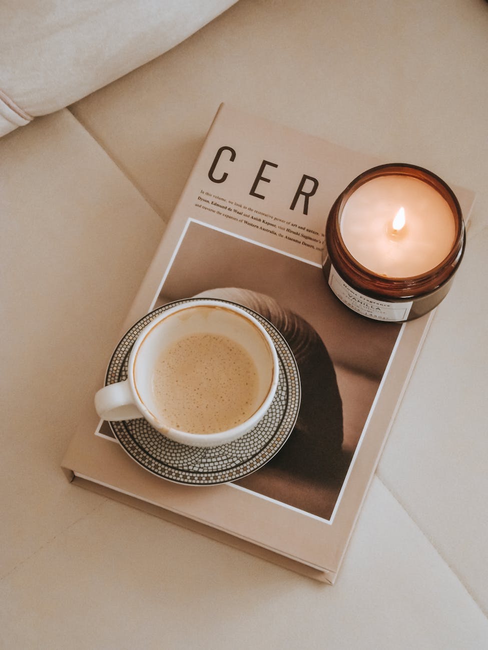 coffee and candle on magazine on couch
